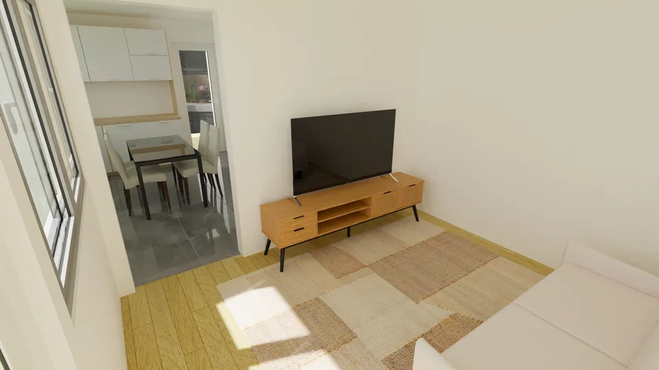 Casa Cerejeira: Sala de estar com TV e a cozinha ao fundo
